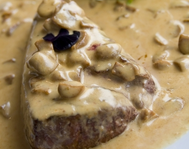 Prime steak with a creamy mushroom sauce